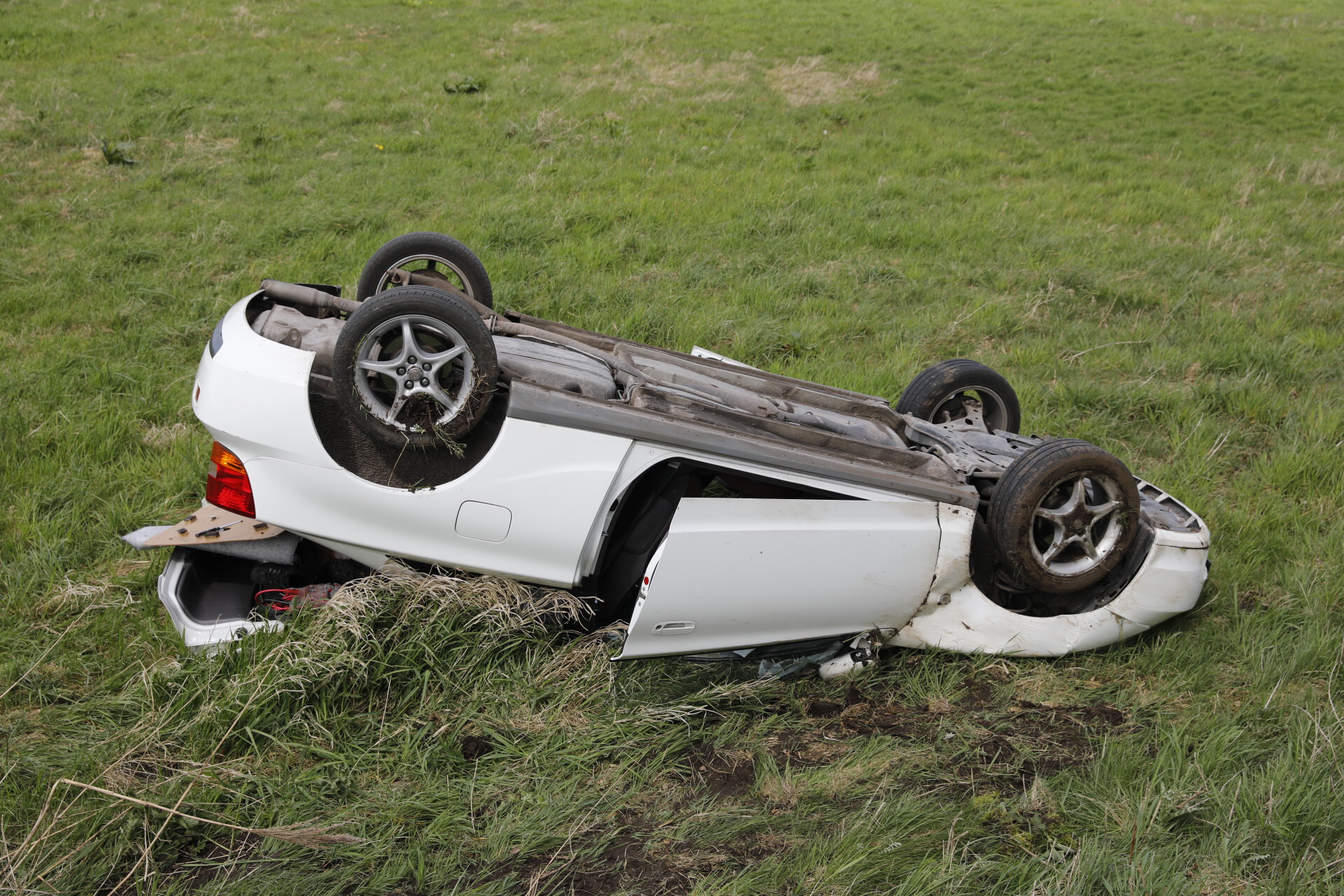 Auto Vliegt Uit Bocht En Belandt Ondersteboven In Weiland